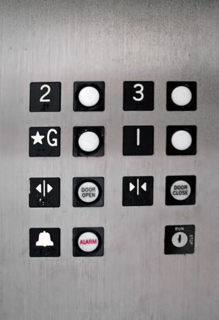 inside of old elevator floor number buttons