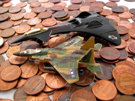 toy military jets sitting on many pennies