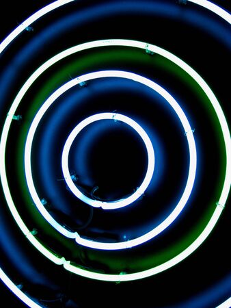 colorful circular light against dark black backgroundの写真素材