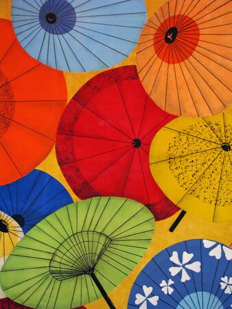 Bright Colorful Oriental Umbrellas Pattern on Yellow Backgroundの写真素材
