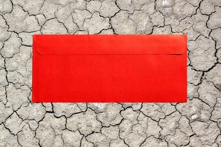 red envelope on Dry soil  with crackの写真素材