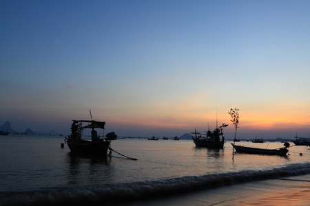 sunset at prachuap bay,thailand and fishing boat の写真素材