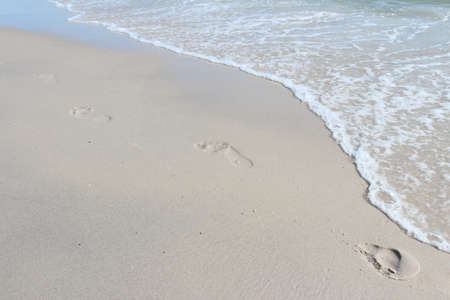 Waves of the sea and footprintの写真素材