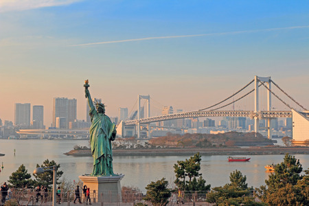 Lady liberty juxtaposed against Rainbow Bridge in Tokyoの写真素材