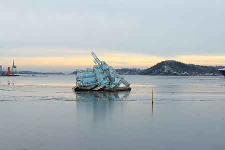 Oslo, Norway - December 30, 2018: She Lies, sculpture floating in the ocean water next to the Opera House of Oslo, Norway.のeditorial素材