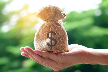 Hand of a woman carrying a purse money .concept saving money and investment conceptの写真素材