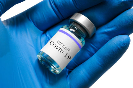 doctor's hand holds a syringe and a blue vaccine bottle at the hospital. Health and medical concepts.の写真素材