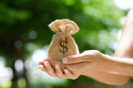 Hand of a woman carrying a purse money .concept saving money and investment conceptの写真素材