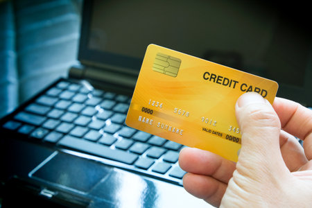 Man holding several credit cards and he is choosing a credit card to pay and spend Payment for goods via credit card. Finance and banking concept.の写真素材