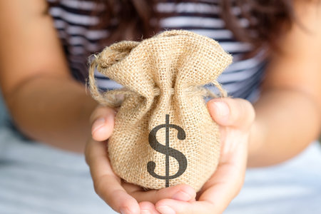 Hand of a woman carrying a purse money .concept saving money and investment conceptの写真素材
