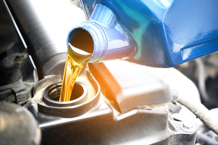 Refueling and pouring oil quality into the engine motor car Transmission and Maintenance Gear .Energy fuel concept.の写真素材