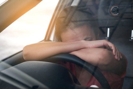 Sleepy woman While she was driving on the road. Concept of health and driving safety