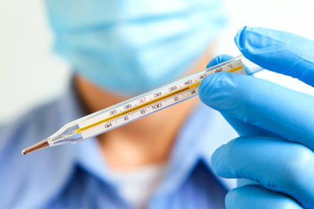 Doctor holding human body temperature thermometer to measure the fever at 37.5 degrees.