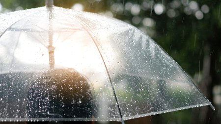 Itâ€™s raining, Women walk in the rain. Hand of women holding an umbrella. She feel sad, Sky...