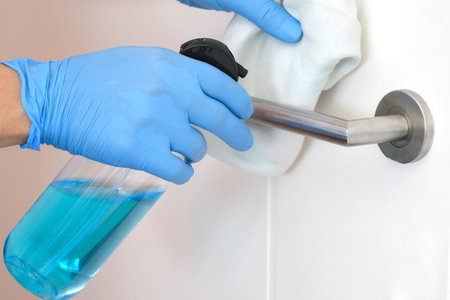 Clean and disinfect the coronavirus  covid 19 with alcohol at the door locks, touch points of...