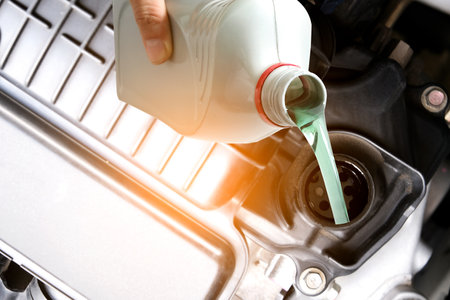 Refueling and pouring oil quality into the engine motor car Transmission and Maintenance Gear .Energy fuel concept.の写真素材