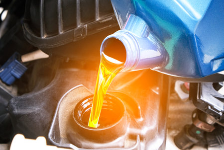 Refueling and pouring oil quality into the engine motor car Transmission and Maintenance Gear .Energy fuel concepの写真素材