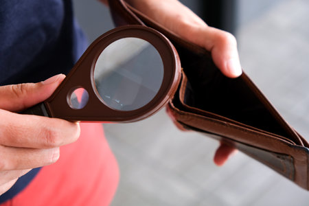 Young woman checking the financial condition in her pocketの写真素材