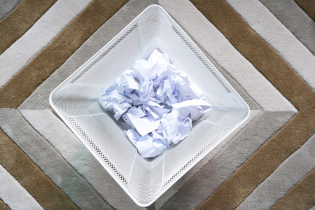 Throwing many crumpled paper ball into black garbage at the office. Its can use recycle or reuse.の写真素材