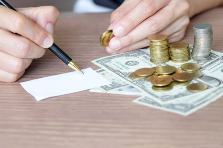 Human hand notes saving money., Coins pile in front of dollar background put on the chart graph for investment. Financial grow up and business conceptsの写真素材