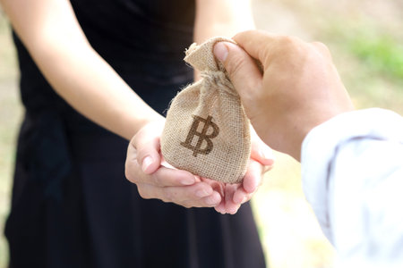 Hand of man give bag on women's hand, mutual aid concept and investment.