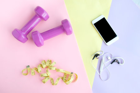 Fitness equipment, Dumbbell shoes, water bottles on wooden floor.Health and Fitness Concepts