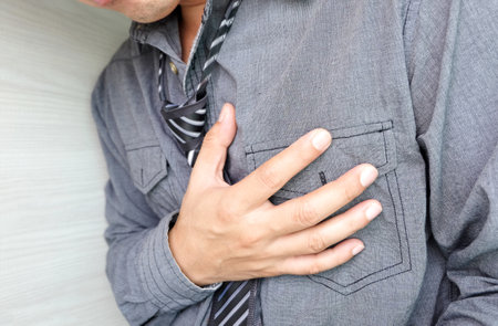 Heart attack, Man standing chest pain in the bedroom Health concept