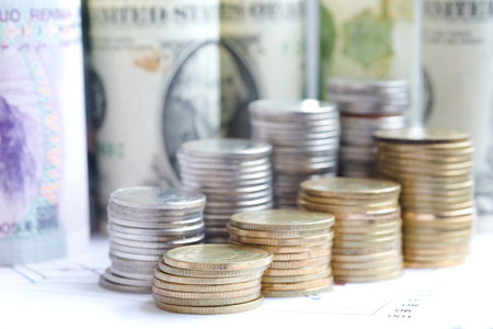 Money , Coins pile in front of dollar background put on the chart graph for investment. Financial grow up and business concepts.の写真素材