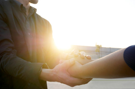 Woman and man holding hands to take care and help each other.の写真素材