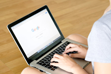 December 5, 2018 Bangkok, Thailand young men use computer laptop internet  looking screen google is social networking service.he surf the Internet to get information of the world.のeditorial素材