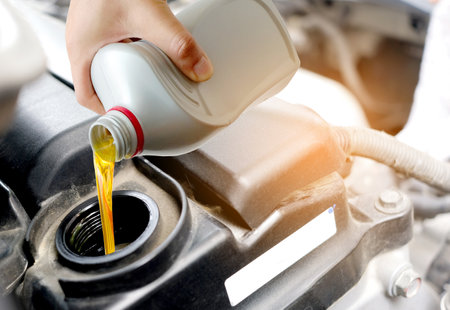 Refueling and pouring oil quality into the engine motor car Transmission and Maintenance Gear .Energy fuel concept.の写真素材