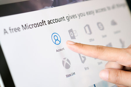 November 25, 2018 in Bangkok, Thailand. Beautiful woman's hand touches her computer screen. And are applying for a system account.のeditorial素材