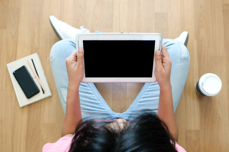 Woman holding a white laptop She is studying to find informationの写真素材