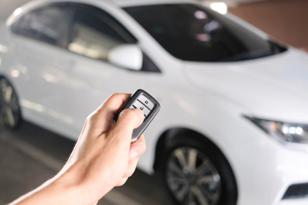 Man hand holding the car remote, he push the remote control to open the car doorの写真素材