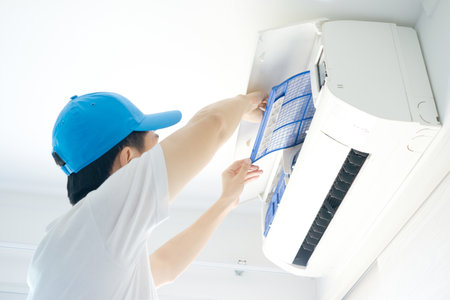 Male repair air conditioner at room, He is air technician , mechanic , engineer. Maintenance air conditioner myself.の写真素材