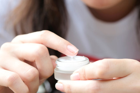 hands of a beautiful woman Dropping serum collagen moisturizer of face into clear yellow bottle soft light background. Protector skin Treatment facial essence oil, Vitamin C. Beauty and spa Conの写真素材