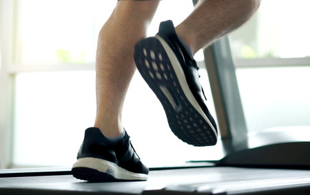 leg of woman running on treadmill in the gym which runner athletic by running shoes. Health and sport concept background,の写真素材