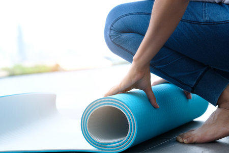 Women are yoga mat  blue rolls. Fitness roomの写真素材
