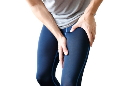athlete has a leg injury and his Thigh holds the leg muscles painfully.