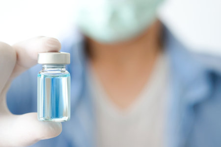 doctor's hand, he holds a bottle of antiretroviral drugs, blue water. Health and medical concepts