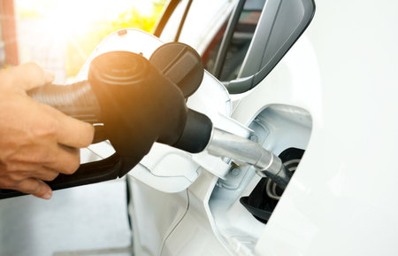 Refueling and pouring oil quality into the engine motor car Transmission and Maintenance Gear .Energy fuel concept.の写真素材