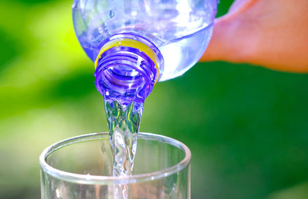 Clean water for good health. Pouring Fresh Pure Water From Pitcher Into A Glass on table wooden. Health And Diet Concept. Lifestyle Healthcare And Beauty.の写真素材