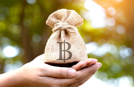 Hand of a woman carrying a purse money .concept saving money and investment conceptの写真素材
