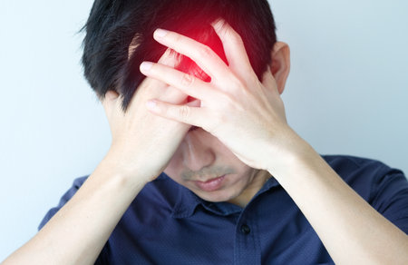 The man sits down, his face still tidy With headaches and stress Causes of sweating and insufficient restの写真素材