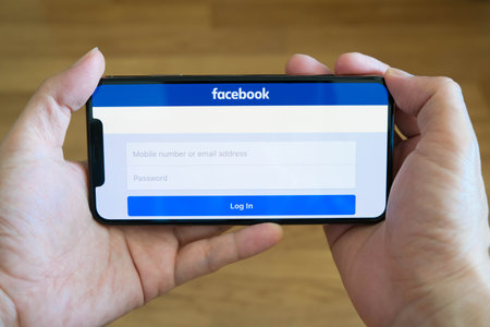 August 5, 2019 Bangkok, Thailand young men use computer laptop internet  looking screen Facebook is social networking service.he surf the Internet to get information of the world.のeditorial素材