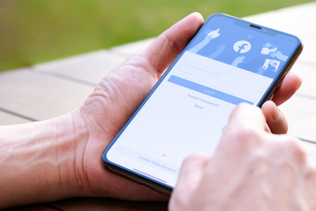 August 5, 2019 Bangkok, Thailand young men use computer laptop internet  looking screen Facebook is...