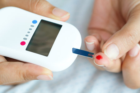 hand of people check diabetes and high blood glucose monitor with digital pressure gauge. Healthcare and Medical conceptの写真素材