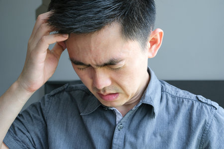 sick man, his face is unhappy, he has headaches and stress. Causes of sweating and insufficient restの写真素材