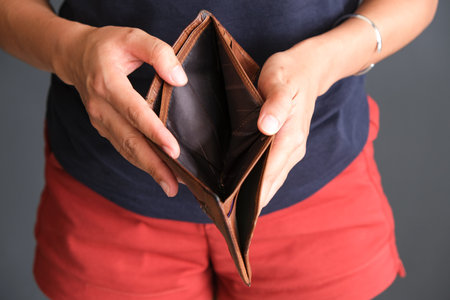 The young man's hand opened his wallet without money.の写真素材