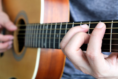 A young man playing string music ukulele in the summerの写真素材